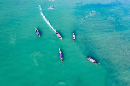 Aerial, drone view of turquoise clear water and longtail boats near Krabi, Thailandの写真素材
