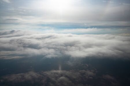 Looking down through dramatic clouds to planet earth.