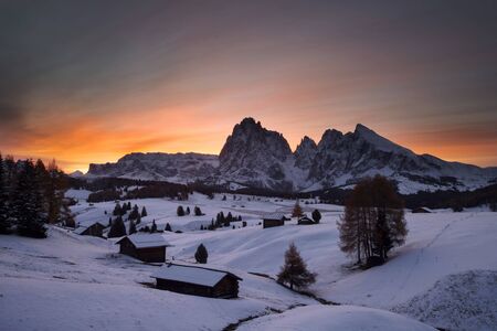 Small cottage in Dolomite mountains in Alpe di Siusil, Italy in winter.の写真素材