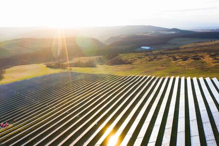 Aerial view of solar panels on a sunny day. Power farm producing clean energy.