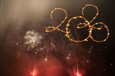 New Year 2020 celebration. Magic holiday background with fireworks. Number 2020 written sparkling sparklers.の写真素材