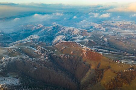 Aerial view of idyllic winter landscape with frozen trees in Transylvania. Winter is coming concept.