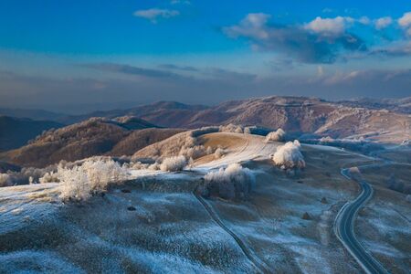 Aerial view of idyllic winter landscape with frozen trees in Transylvania. Winter is coming concept.