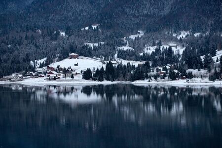 Winter magic landscape with scenic frozen mountain lake at Colibita, Romania.の写真素材