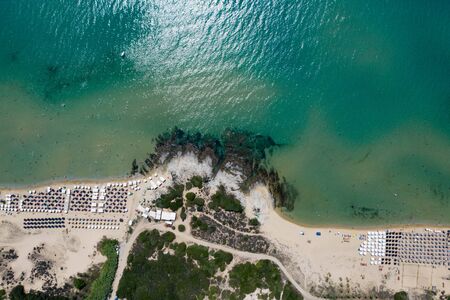 Aerial view of amazing beach with umbrellas and turquoise sea in Greece. Travel concept.