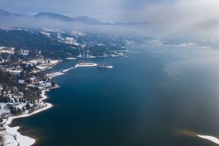 Winter magic landscape with scenic frozen mountain lake at Colibita, Romania.の写真素材