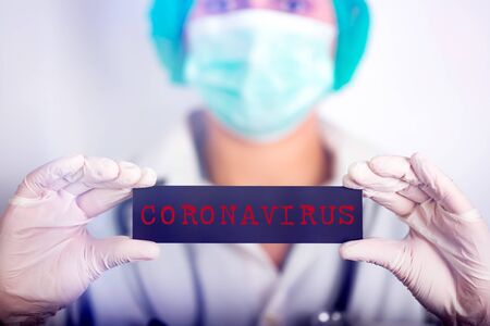 Concept of COVID-19 - Coronavirus disease - 2019-nCoV,  coronavirus.Doctor holding the inscription coronovirus COVID-19の写真素材