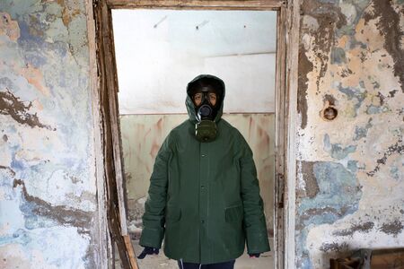 Post apocalyptic survivor in gas mask in a ruined building. Environmental disaster, armageddon...