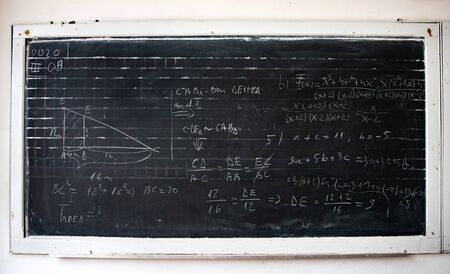 Blackboard inscribed with scientific formulas and calculations in mathematics. Science and education...