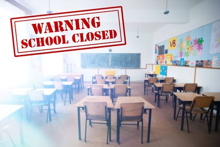COVID-19 - Coronavirus pandemic - 2019-nCoV concept. Empty classroom with a the text of Closed school. Many countries orders closure of all schools and universities due to coronavirus outbreak.の写真素材