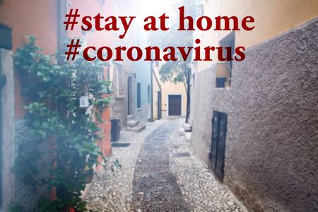 Staying at home with self quarantine to help slow outbreak and protect coronavirus spread.Italian village street with stay at home text.の写真素材