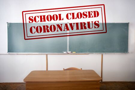 COVID-19 - Coronavirus pandemic - 2019-nCoV concept. Empty classroom with a the text of Closed school. Many countries orders closure of all schools and universities due to coronavirus outbreak.の写真素材