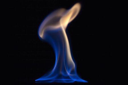 Glasses with burning alcohol on black background.の写真素材