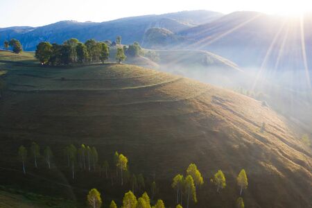 Aerial view of endless lush pastures of Transylvania. Beautiful romanian countryside with emerald...