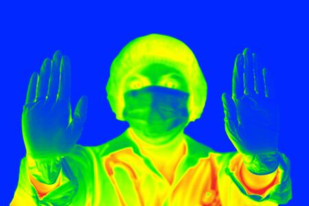 Thermal scanner detecting infected people with Covid-19. Coronavirus spread control concept.の写真素材