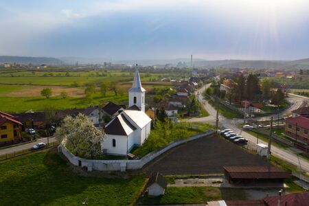 Aerial view of a small village with old church in Transylvania, Romania.の写真素材