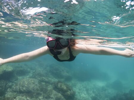 Women snorkeling in the tropical sea. Traveling, active lifestyle concept.