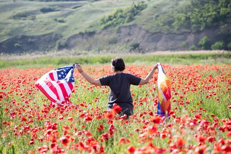 Woman holding LGBT and USA flag in poppy field. Gay equal rights and LGBT sexual freedom in America...
