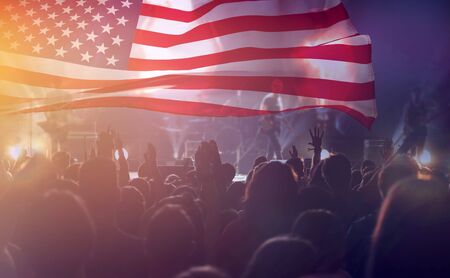 Crowd of people celebrating Independence Day. United States of America USA flag with fireworks background for 4th of July.の写真素材