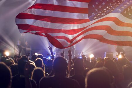 Crowd of people celebrating Independence Day. United States of America USA flag with fireworks background for 4th of July.の写真素材