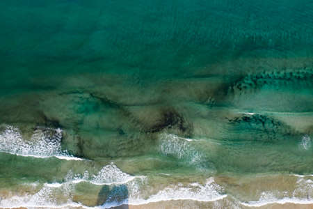 Aerial view of tropical sandy beach and blue ocean with crystal clear turqouise water. Abstract...