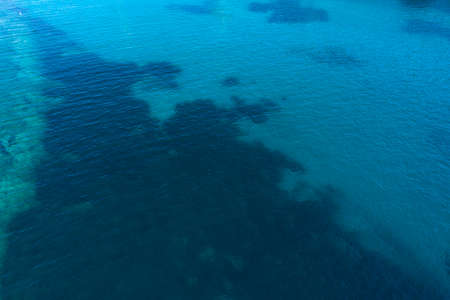 Aerial view on turquoise waves, water surface texture.