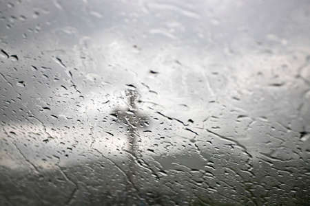 Dramatic religious photo of cross on a rainy day.