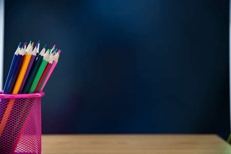 Back to school concept.Colorful pencils on chalkboard background.
