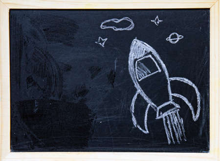 Back to school concept with hand drawn rocket on blackboard.の写真素材