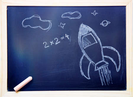 Back to school concept with hand drawn rocket on blackboard.の写真素材