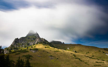 Scenic view of Ciucas rock mountains in fog, Romania.の写真素材