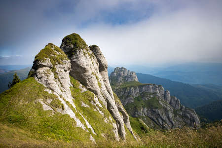 Scenic view of Ciucas rock mountains in fog, Romania.の写真素材