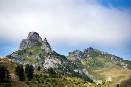 Scenic view of Ciucas rock mountains in fog, Romania.