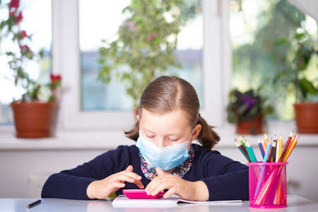 School child wearing mask for protection against virus in school. Measures to prevent the spread virus.の写真素材