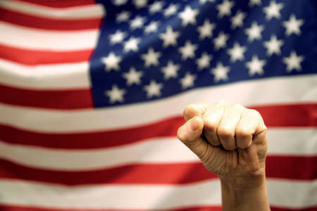 Man's fist over USA flag.United States elections 2020 concept.