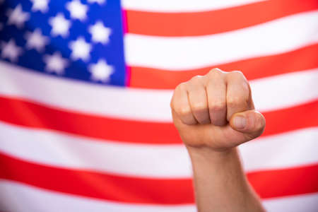 Man's fist over USA flag.United States elections 2020 concept.の写真素材