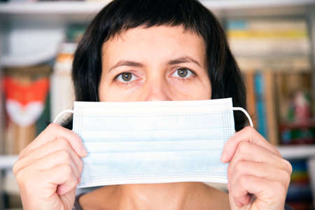 Woman wearing an anti virus protection mask to prevent others from corona, COVID-19 infection
