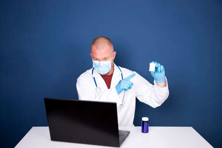 Male doctor consulting patient by online video call on laptop. Remote online medical chat...