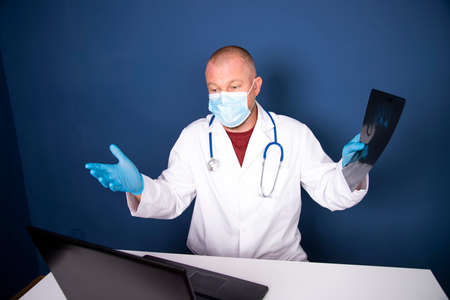 Male doctor consulting patient by online video call on laptop. Remote online medical chat...