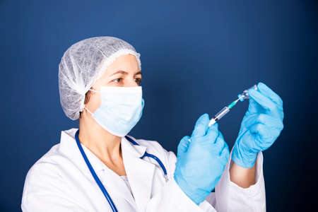 Concept of COVID-19 - Coronavirus disease - 2019-nCoV, WUHAN corona virus. Doctor with syringe is...