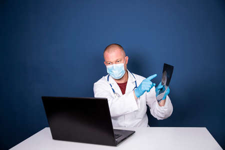 Male doctor consulting patient by online video call on laptop. Remote online medical chat...