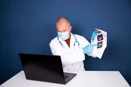 Male doctor consulting patient by online video call on laptop. Remote online medical chat consultation, tele medicine distance services, virtual physician conference call, telemedicine concept.の写真素材