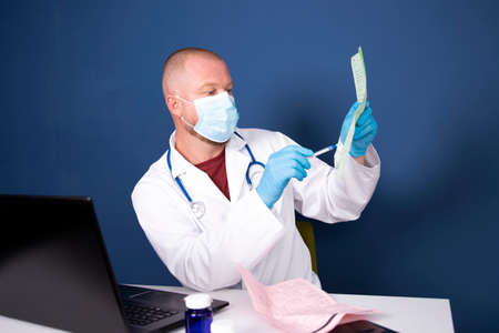 Male doctor consulting patient by online video call on laptop. Remote online medical chat...
