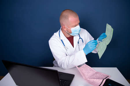Male doctor consulting patient by online video call on laptop. Remote online medical chat...