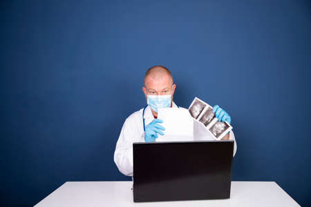 Male doctor consulting patient by online video call on laptop. Remote online medical chat...