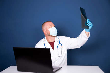 Male doctor consulting patient by online video call on laptop. Remote online medical chat...
