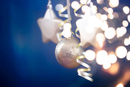 Holiday background with golden christmas decorations and magic holiday light.の写真素材