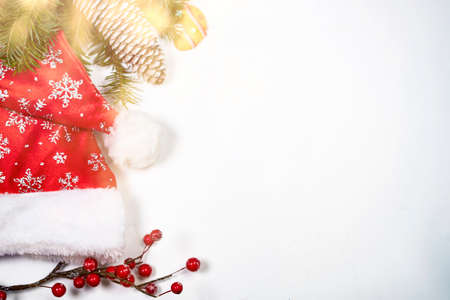 Christmas background with gingerbread cookies, Santa hat and pine tree branch on white.の写真素材