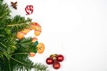 Christmas background with gingerbread cookies and pine tree branch on white.の写真素材