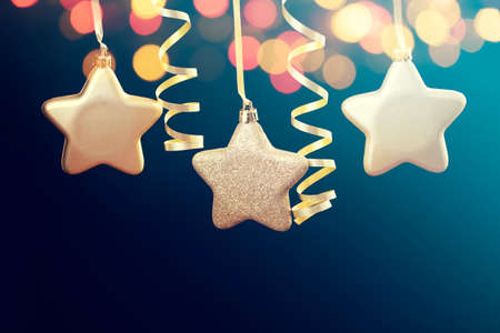 Holiday background with golden christmas decorations and magic holiday light.の写真素材